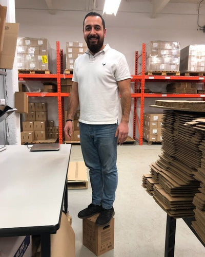 Man standing on a box in a warehouse