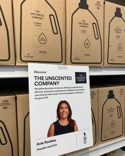Display of The Unscented Company laundry boxes with a sign showing the founder