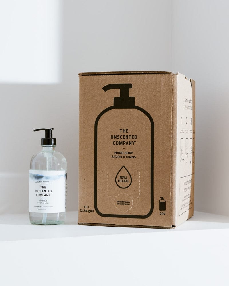 Box and bottle of The Unscented Company hand soap on a white counter.