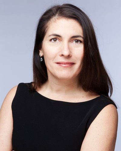 Portrait of a woman in a black dress with long dark hair.