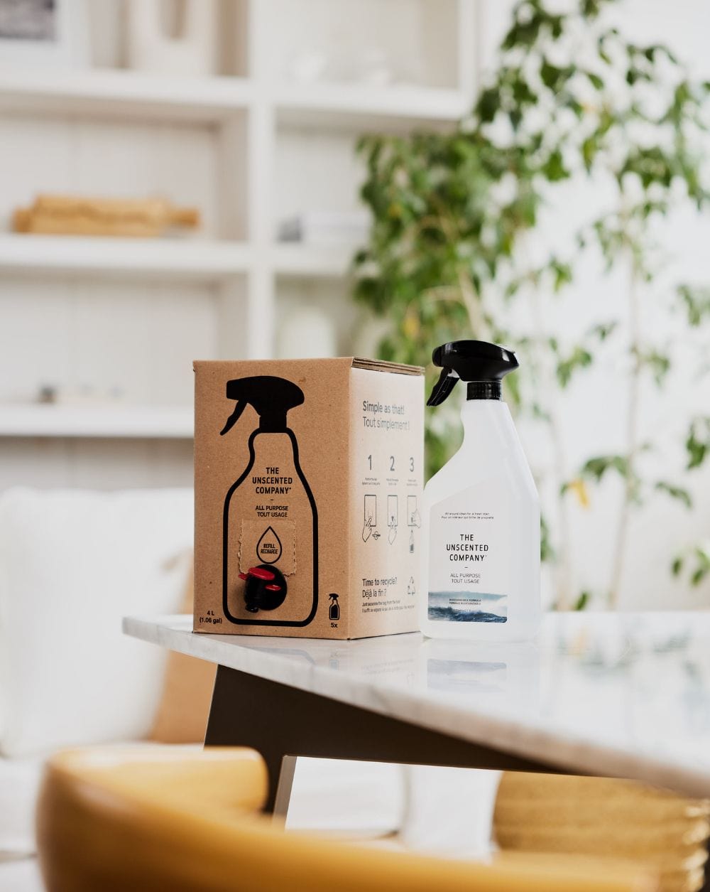 Box and spray bottle of The Unscented Company all-purpose cleaner on a table.