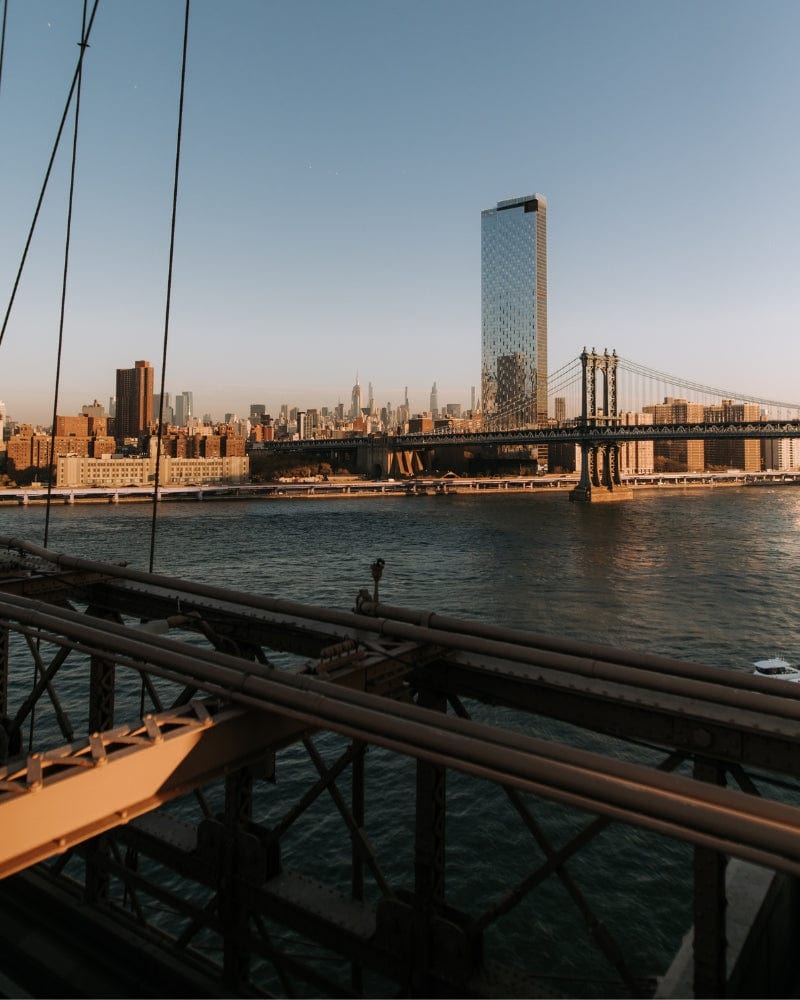 View of Manhattan and the Manhattan Bridge from the Brooklyn Bridge at sunset.