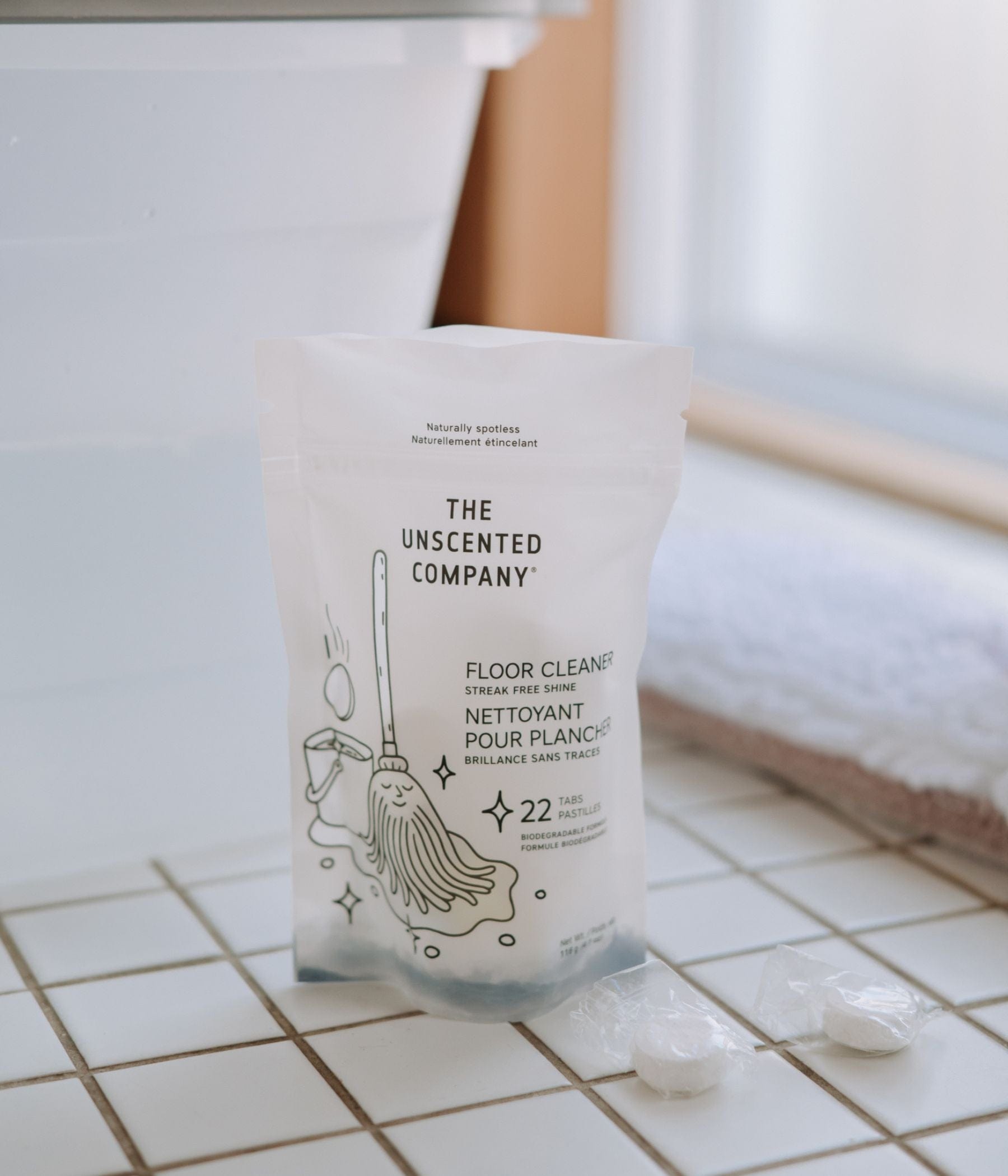 The Floor Cleaner - 22 tabs placed on tiles with two tabs next to the pouch.