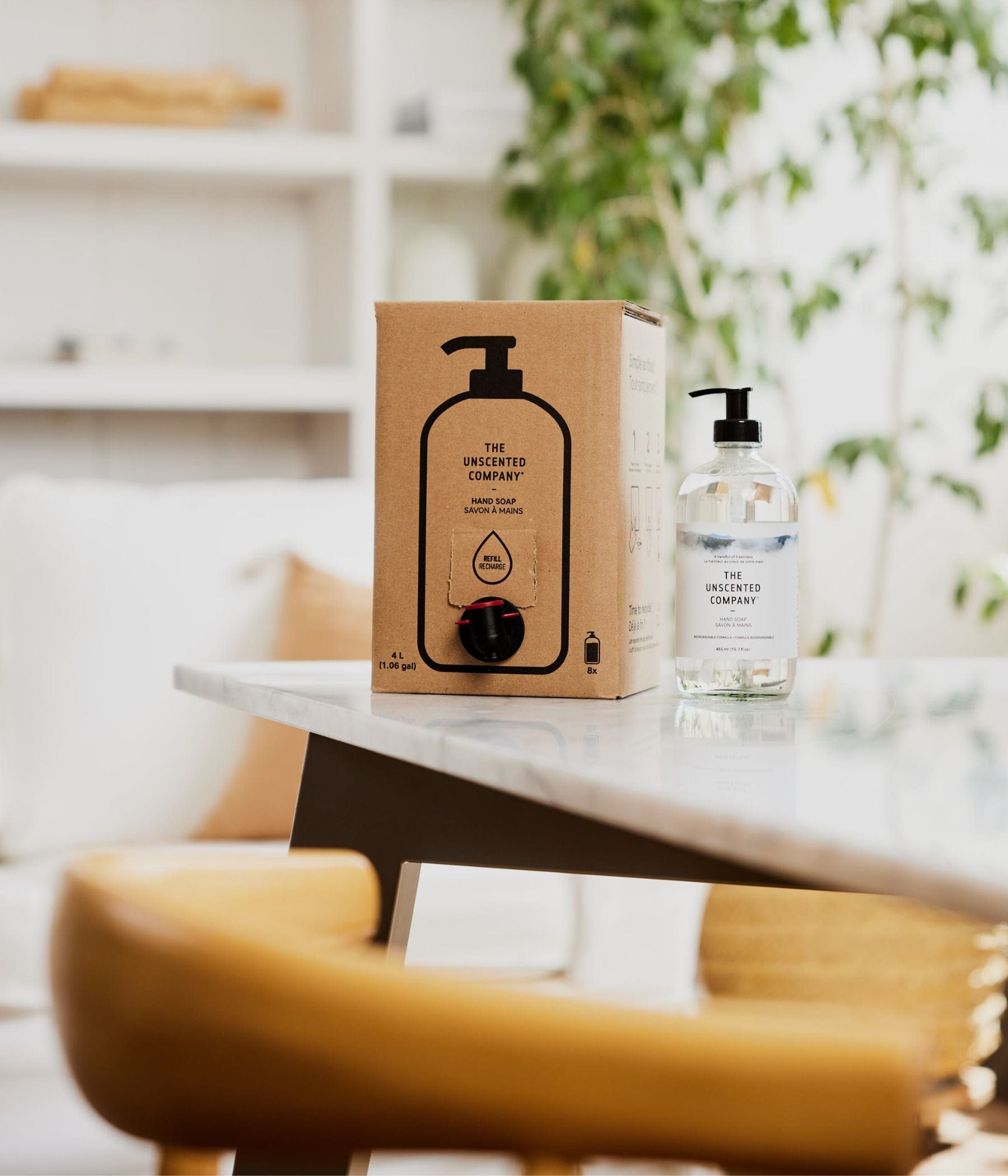 The Unscented Company hand soap refill box and bottle on a table.