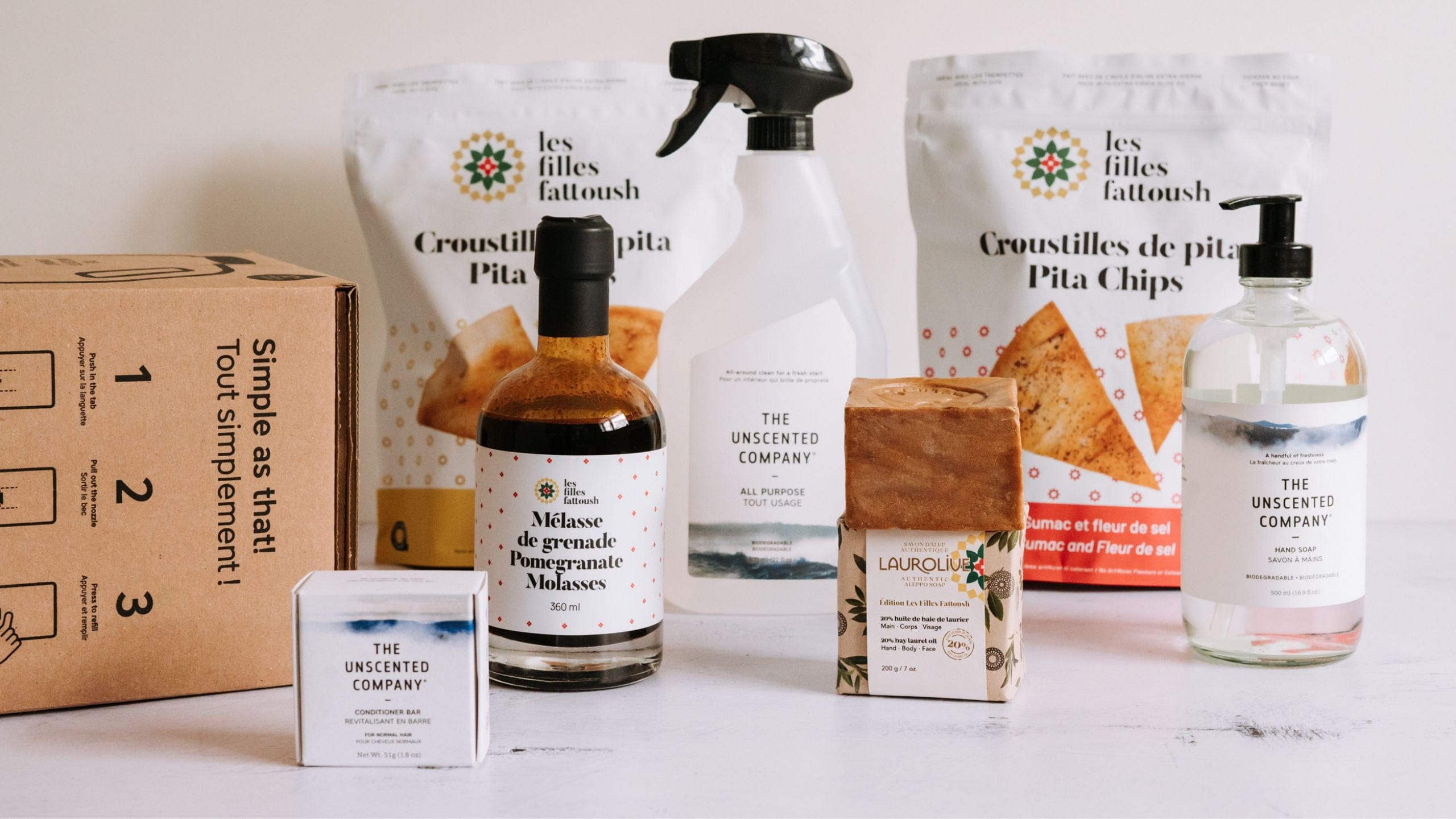 Assorted products including pita chips, pomegranate molasses, soap, and unscented company cleaner.