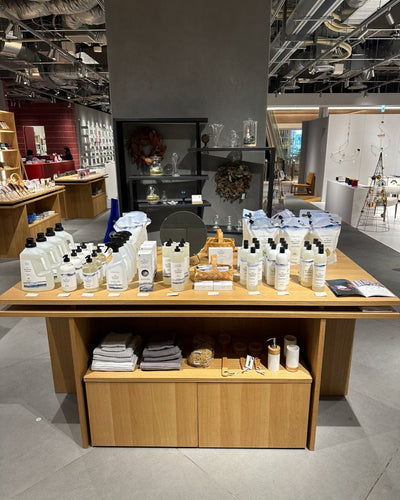 Display table featuring The Unscented Company home and body care products inside a modern lifestyle store in Japan, highlighting refillable, fragrance-free and sustainable cleaning solutions.