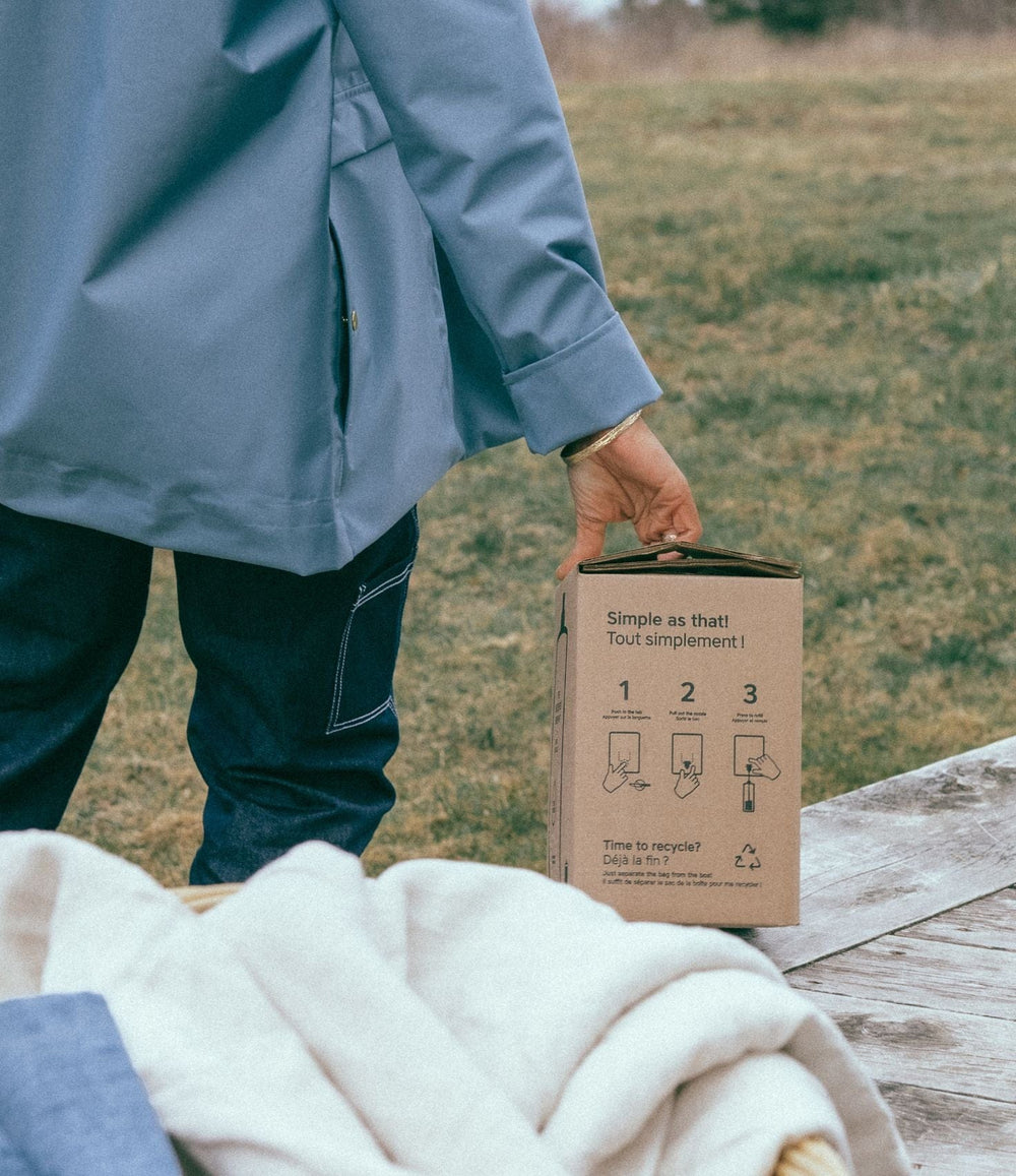 Person holding a refill box outside.