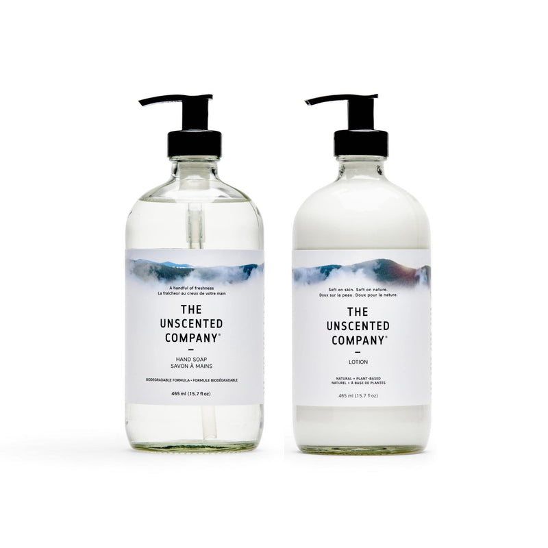 The Unscented Company fragrance-free hand soap and lotion duo in clear reusable glass bottles, photographed on a white background.