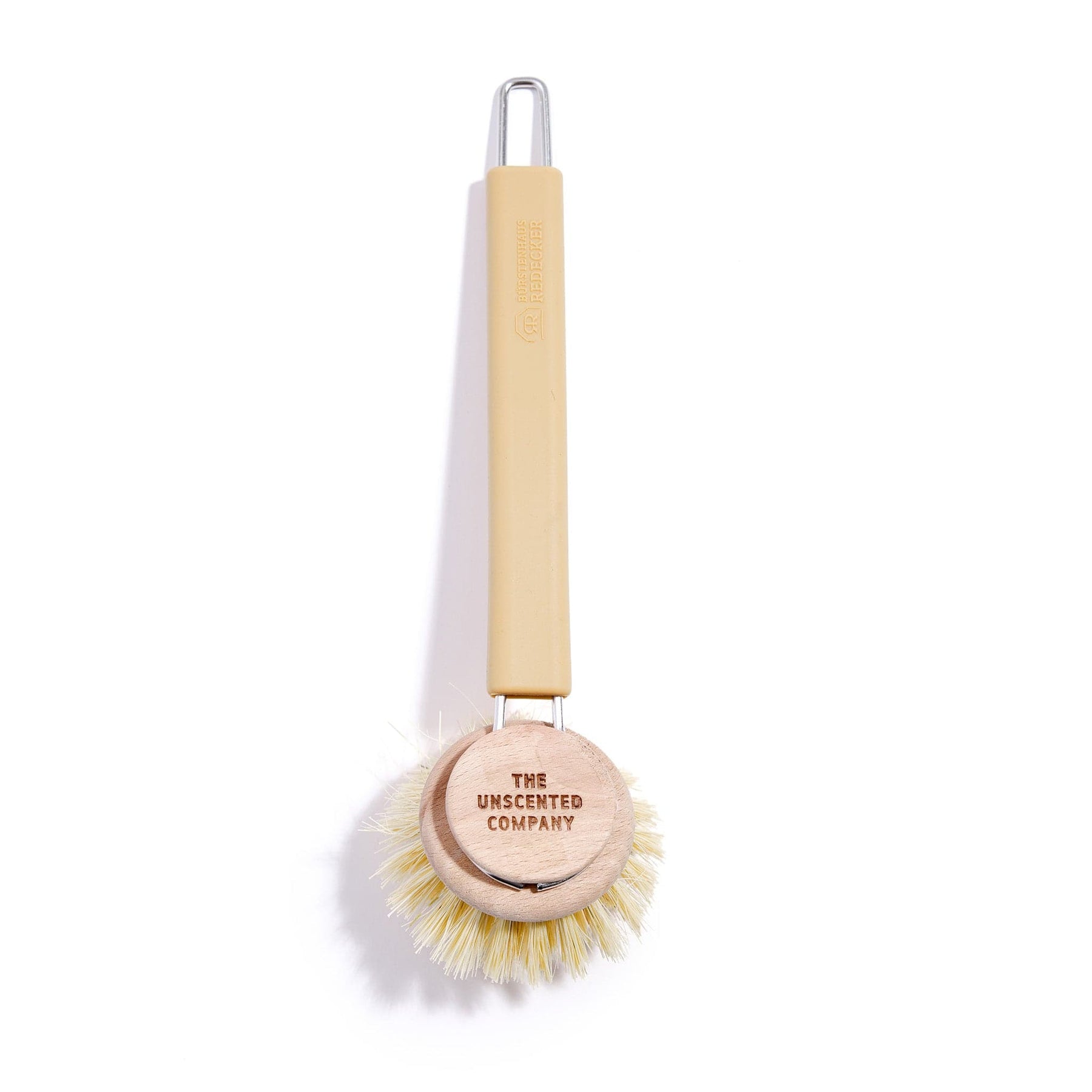 The Unscented Company dish brush with natural bristles and a wooden head.