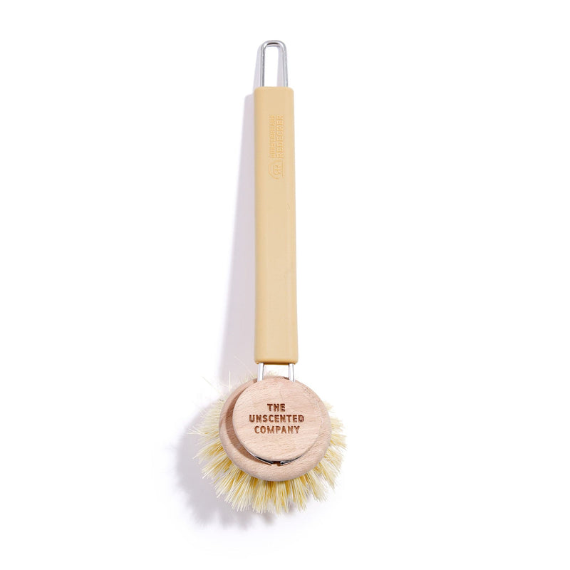 The Unscented Company dish brush with natural bristles and a wooden head.