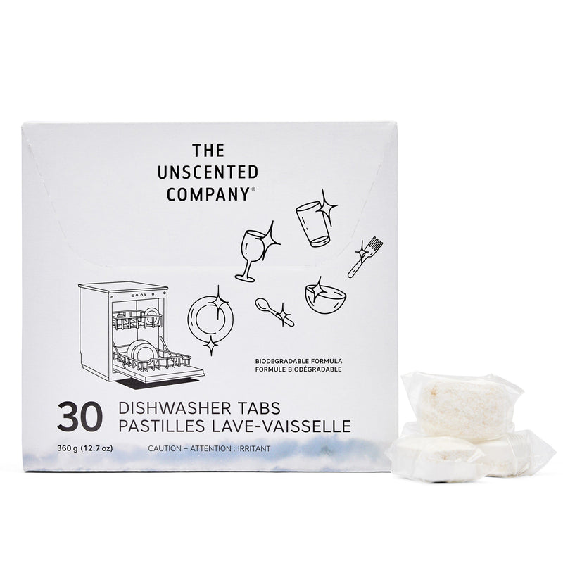 Front view of The Unscented Company dishwasher tabs box (30 count). The packaging is white with black illustrations of sparkling dishes and utensils. Includes branding, bilingual product name (Dishwasher Tabs / Pastilles Lave-Vaisselle), and two visible individually wrapped tabs placed beside the box. States “Biodegradable Formula” and highlights weight: 360 g (12.7 oz).