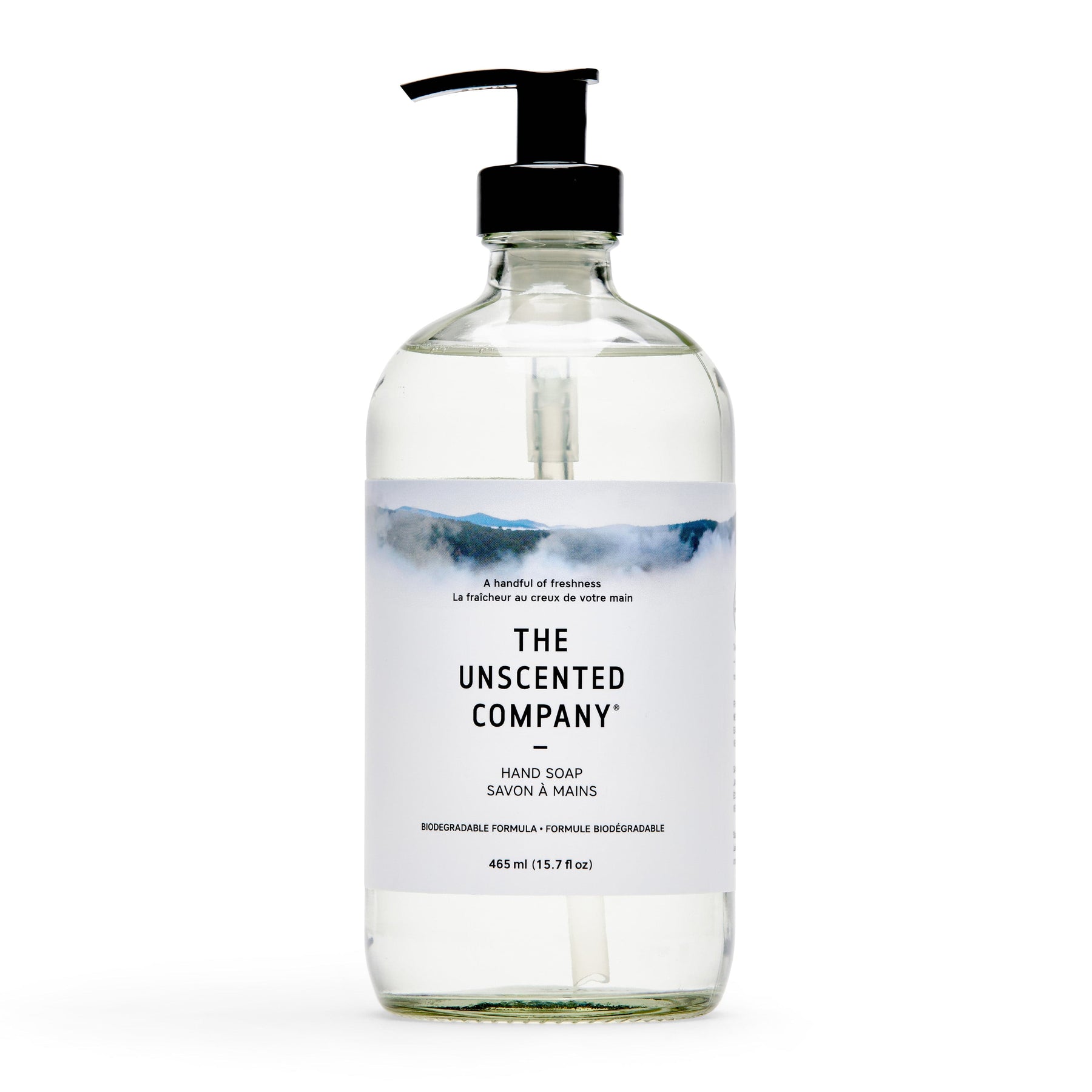 Front of hand soap bottle, clear with pump, labeled The Unscented Company.
