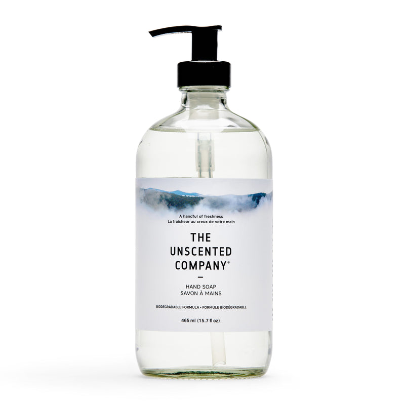 Front of hand soap bottle, clear with pump, labeled The Unscented Company.