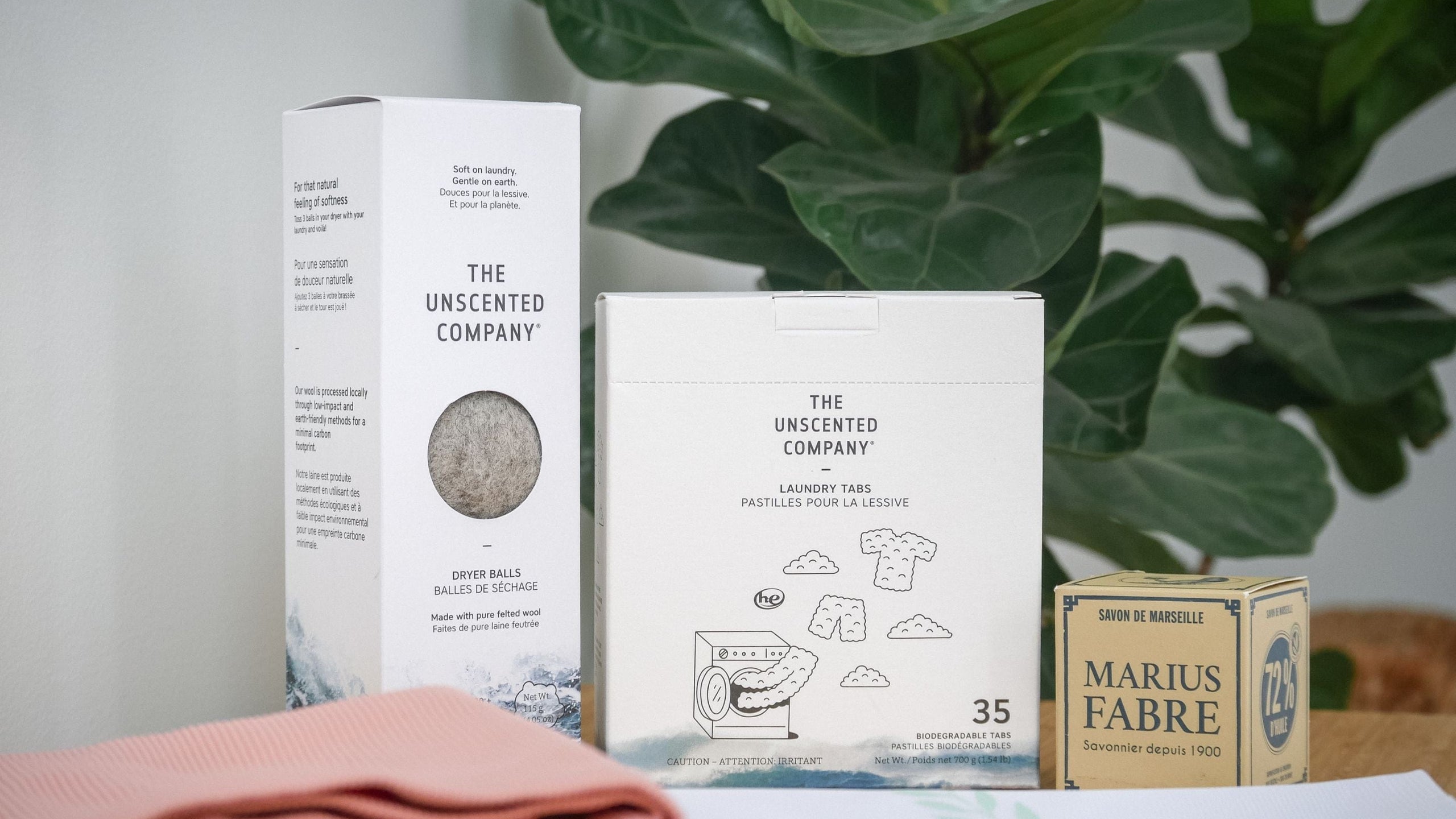 The Unscented Company laundry tabs and dryer balls next to Marius Fabre soap