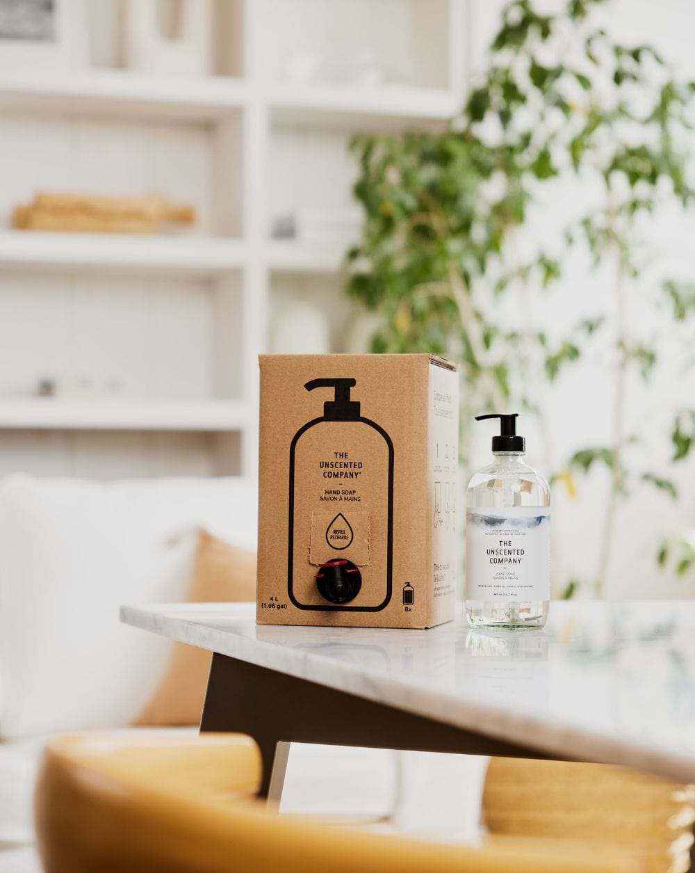 Box and bottle of The Unscented Company hand soap on a table.