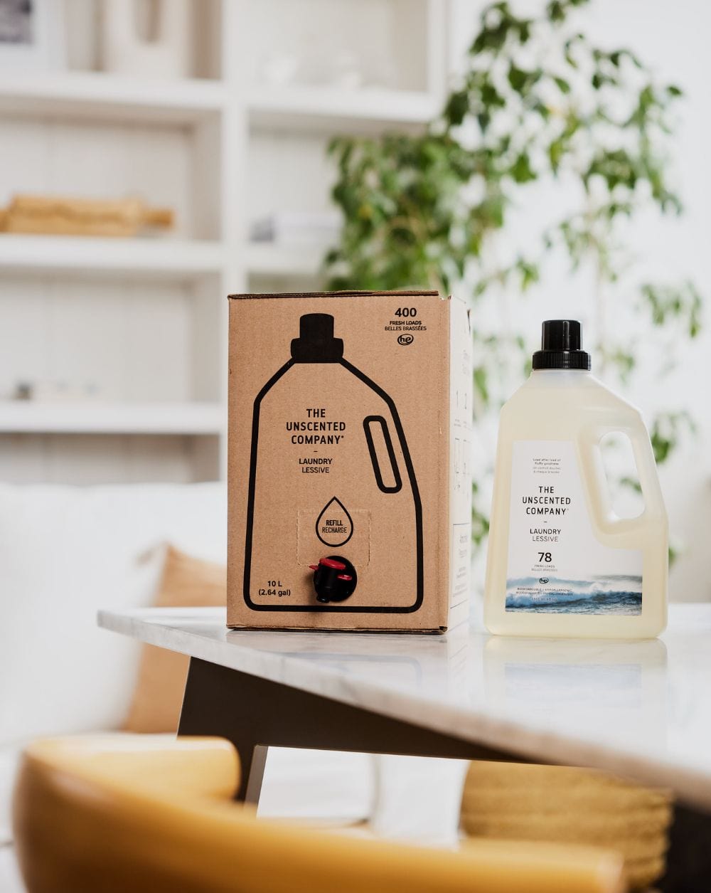 Box and bottle of The Unscented Company laundry detergent on a table.