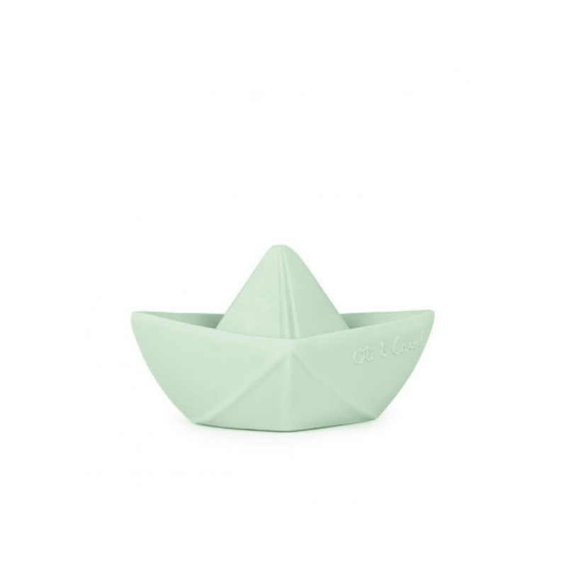 A small mint green silicone toy shaped like a paper boat.
