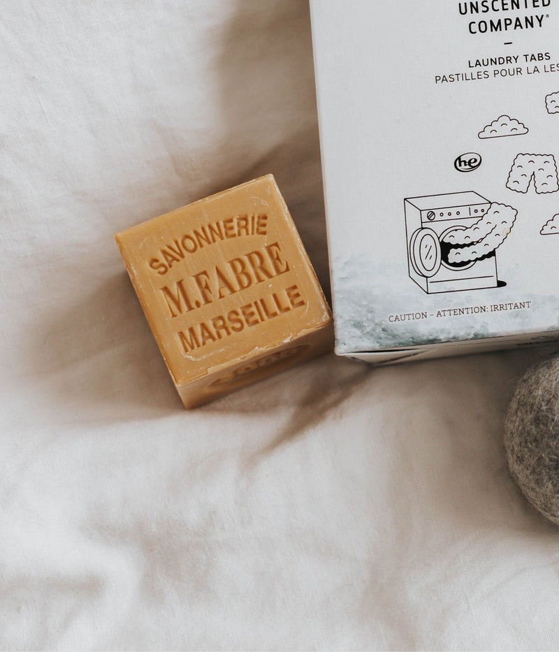  Marseille soap and The Unscented Company laundry tabs on white fabric.