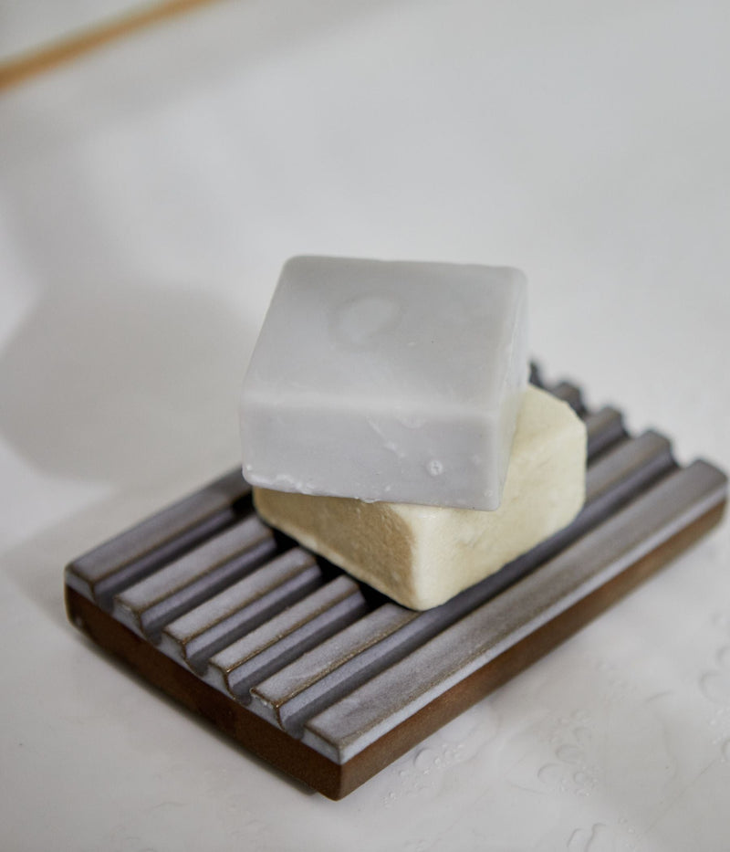Two soap bars stacked on a soap dish.