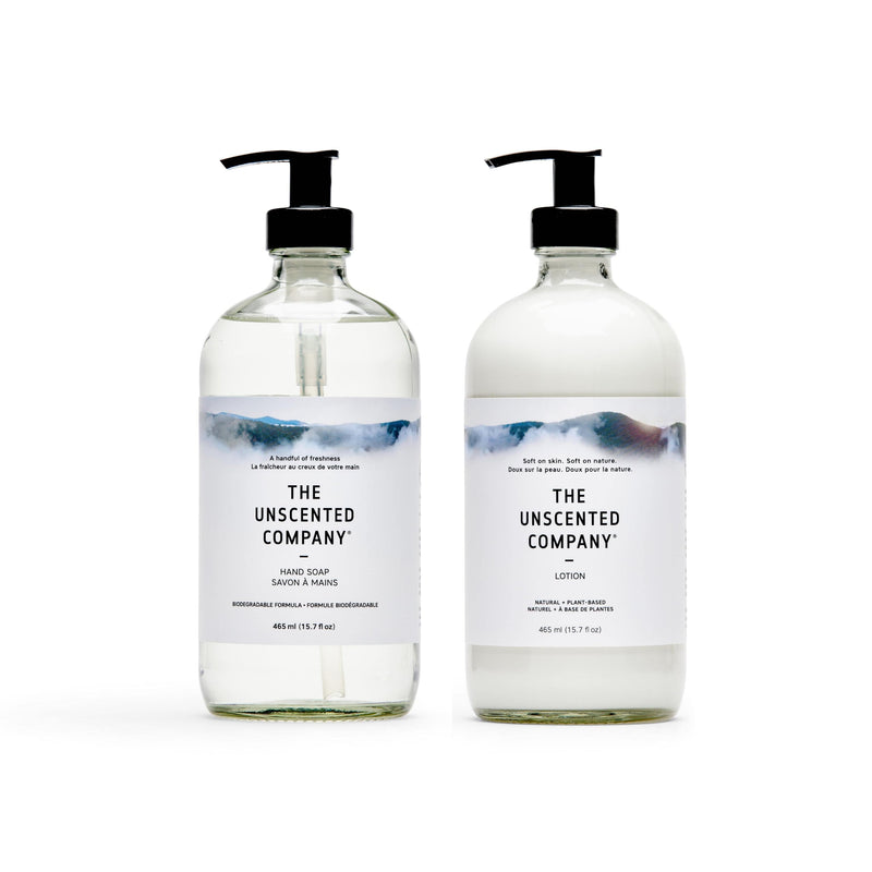 The Unscented Company fragrance-free hand soap and lotion duo in clear reusable glass bottles, photographed on a white background.