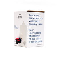 Side view of The Unscented Company 4 L dish soap box with dispenser tap, featuring the text “Keeps your dishes and our waterways squeaky clean,” on minimalist white eco-friendly packaging.
