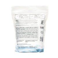 Dos du sac de lessive délicate The Unscented Company affichant les instructions d’utilisation, les mises en garde, la liste d’ingrédients et les certifications, sur fond blanc.