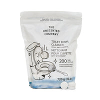 A pouch of The Unscented Company Toilet Bowl Cleaner featuring playful line art of a smiling toilet being scrubbed, labeled with product details in English and French, and showing three white cleaning tablets in front of the 720g package.